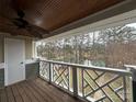 Balcony with white decorative railing overlooking a lush, wooded area, offering a serene outdoor space at 20123 Henderson Rd # L, Cornelius, NC 28031