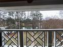A serene lake view is visible behind the decorative white railing, offering a tranquil scene at 20123 Henderson Rd # L, Cornelius, NC 28031
