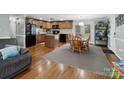 Cozy kitchen with wood cabinets, hardwood floors, island and connected dining space at 2200 Peninsula Ave, Shelby, NC 28150
