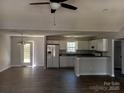 Bright, open-concept living room and kitchen with modern appliances and stylish flooring at 247 N Burris Rd, Sharon, SC 29742