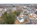 Aerial view of a residential neighborhood featuring well-maintained homes and mature trees at 303 Cupped Oak Ct, Charlotte, NC 28213