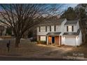 Charming two-story home with brick and siding, attached garage, and well-maintained front yard at 303 Cupped Oak Ct, Charlotte, NC 28213