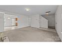 Spacious Living room leading to a kitchen and stairs at 303 Cupped Oak Ct, Charlotte, NC 28213