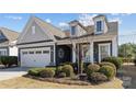 Well-maintained home exterior featuring an attached two-car garage and manicured landscaping at 305 Kentmere Ln, Clover, SC 29710