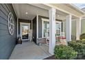 Inviting front porch with rocking chairs, decorative accents, and classic columns at 305 Kentmere Ln, Clover, SC 29710