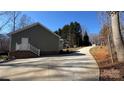 Side exterior of home with a brick foundation and long winding driveway at 312 Sailwinds Rd, Mooresville, NC 28115