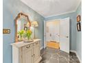 Hallway with blue walls, slate floors, a decorative mirror, and entry to the closet at 3625 Mill Pond Rd, Charlotte, NC 28226