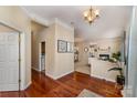 Open foyer featuring hardwood floors, and a view into the living room with fireplace at 418 Garnet Ct, Fort Mill, SC 29708