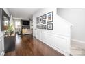 Inviting entryway boasting dark wood floors, crisp white trim, and a gallery wall of framed pictures at 4729 Abercromby St, Charlotte, NC 28213