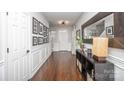 Inviting entryway featuring dark wood floors, white trim, and a stylish console table with decor at 4729 Abercromby St, Charlotte, NC 28213