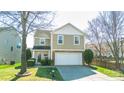 Charming two-story home featuring a stone accent facade, attached garage, and well-manicured lawn at 4729 Abercromby St, Charlotte, NC 28213