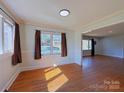 Inviting room with hardwood floors, and large windows providing plenty of natural light at 4800 Kipling Dr, Charlotte, NC 28212