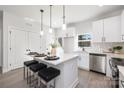 Modern kitchen with stainless steel appliances, a center island with seating, and ample cabinet space at 4903 Victoria Ave, Charlotte, NC 28269