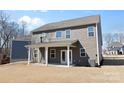Home featuring a covered patio, ample backyard space, and neutral-toned siding at 491 Creevy Nw Dr, Concord, NC 28027