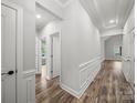Bright hallway with paneled walls, wood floors, and decorative trim throughout the home at 5101 Thornhill Dr, Gastonia, NC 28052