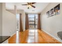 Bright living room with hardwood floors and a large window offering natural light at 525 E Sixth St # 208, Charlotte, NC 28202