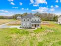 Charming two-story home with a well-maintained lawn, surrounded by a wooden fence, creating a picturesque suburban setting at 5405 Austin Rd, Monroe, NC 28112