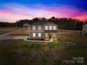 Stunning two-story home featuring a gray exterior, a welcoming porch, and a spacious front yard at 5405 Austin Rd, Monroe, NC 28112
