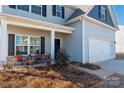 Inviting front porch with stone accents, seating, and a well-maintained yard at 6015 Ahoskie Dr, Charlotte, NC 28215