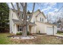 Two-story home with a vinyl siding, attached garage and landscaped yard with mature tree at 6027 Edinmeadow Ln # 29, Charlotte, NC 28269