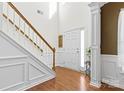 Bright foyer with beautiful hardwood floors, staircase, and detailed trim work at 7003 Dacian Ln, Indian Trail, NC 28079