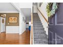 Inviting foyer showcasing a staircase and hardwood floors, with a view into other rooms at 7003 Dacian Ln, Indian Trail, NC 28079