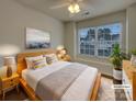Stylishly staged bedroom boasts a ceiling fan, bedside tables and an ample window view at 725 Rock Lake Gln, Fort Mill, SC 29715