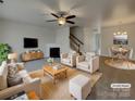 Bright, staged living room featuring a fireplace, modern ceiling fan and dining area at 725 Rock Lake Gln, Fort Mill, SC 29715