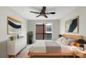 Bedroom featuring a ceiling fan, neutral walls, a large window, and modern decor at 7340 Winery Ln, Charlotte, NC 28227