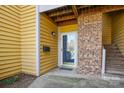 Charming entrance with yellow siding, brick accent, and stairs to the unit at 766 Marsh Rd # Apt 2, Charlotte, NC 28209