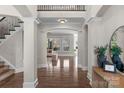 Elegant foyer showcasing hardwood floors and architectural columns into living space at 805 Hidden Pond Ln, Waxhaw, NC 28173