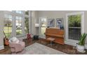 Cozy room with large windows, filled with natural light and a stylish piano at 805 Hidden Pond Ln, Waxhaw, NC 28173