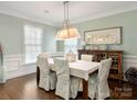 Formal dining room with wainscoting, classic furnishings, and elegant chandelier lighting at 875 Stratford Run Dr, Fort Mill, SC 29708