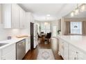 Spacious eat-in kitchen with white cabinets, stainless appliances, and dark hardwood floors at 875 Stratford Run Dr, Fort Mill, SC 29708