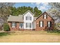 Attractive brick and siding home with a manicured lawn and blossoming trees at 919 42Nd Avenue Ne Ln, Hickory, NC 28601