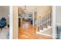 Inviting foyer with hardwood floors, staircase, and open view to the living room with a fireplace at 919 42Nd Avenue Ne Ln, Hickory, NC 28601