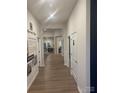 Bright hallway with wood-look floors leads to open living spaces and bedrooms at 1429 Nia Rd, Charlotte, NC 28215