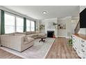 Bright living room with large windows, fireplace, neutral color palette, and an open layout at 2408 Napa Ter, Clover, SC 29710