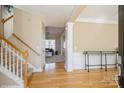 Bright foyer featuring hardwood floors, a staircase, and an open view to the living spaces at 6816 Charter Hills Rd, Charlotte, NC 28277