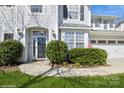 Inviting entryway with a clear glass door, decorative shrubbery, and a 'Welcome' sign at 6816 Charter Hills Rd, Charlotte, NC 28277