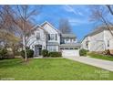 Attractive two-story home with a well-kept lawn, a two-car garage, and a welcoming front entrance at 6816 Charter Hills Rd, Charlotte, NC 28277