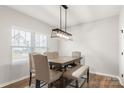Bright dining room with a large wooden table, seating for six, and a modern chandelier at 838 Foxglove Ln, York, SC 29745