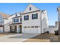 Charming two-story home with black shutters, neutral siding, and a two-car garage at 838 Foxglove Ln, York, SC 29745