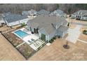 An aerial shot reveals a backyard with a pool, spa, and lounge area at 107 Hillside Cove Ct, Mooresville, NC 28117