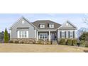 Charming single-Gathering home with stone accents, gray siding, shutters, and a well-manicured lawn at 107 Hillside Cove Ct, Mooresville, NC 28117