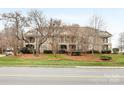 Exterior shot of condo building, showcasing the well-maintained landscaping, and beautiful design at 1121 Park West Dr, Charlotte, NC 28209