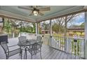 Relaxing back porch area with a ceiling fan, providing a serene outdoor dining space and overlooking the backyard at 117 Maple Hill Rd, Monroe, NC 28110