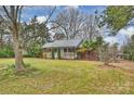 Beautiful single story home with well-maintained lawn and mature trees surrounding the property at 117 Maple Hill Rd, Monroe, NC 28110