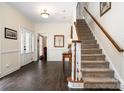 Inviting foyer with hardwood floors, staircase, and elegant decor at 125 High Sail Ct, Mooresville, NC 28117