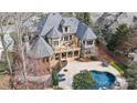 Expansive property featuring a large in-ground pool, multiple balconies, and lush landscaping at 1312 Lookout Cir, Waxhaw, NC 28173